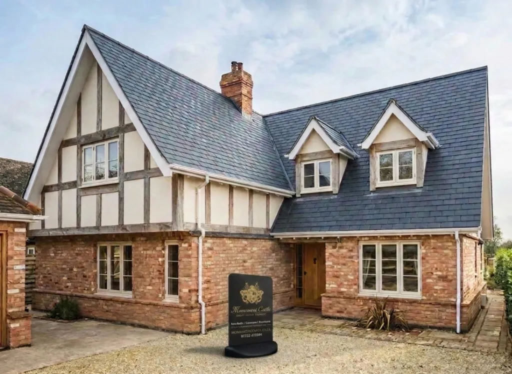 Family house with a new slate roof and Monument Castle board outside